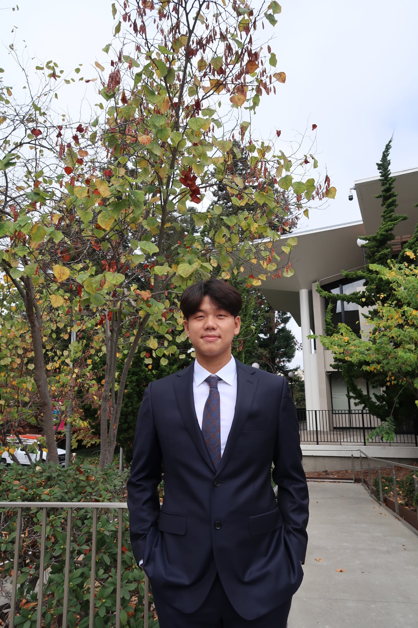 Jaehyeok (Jayden) Choi wearing a suit outdoors